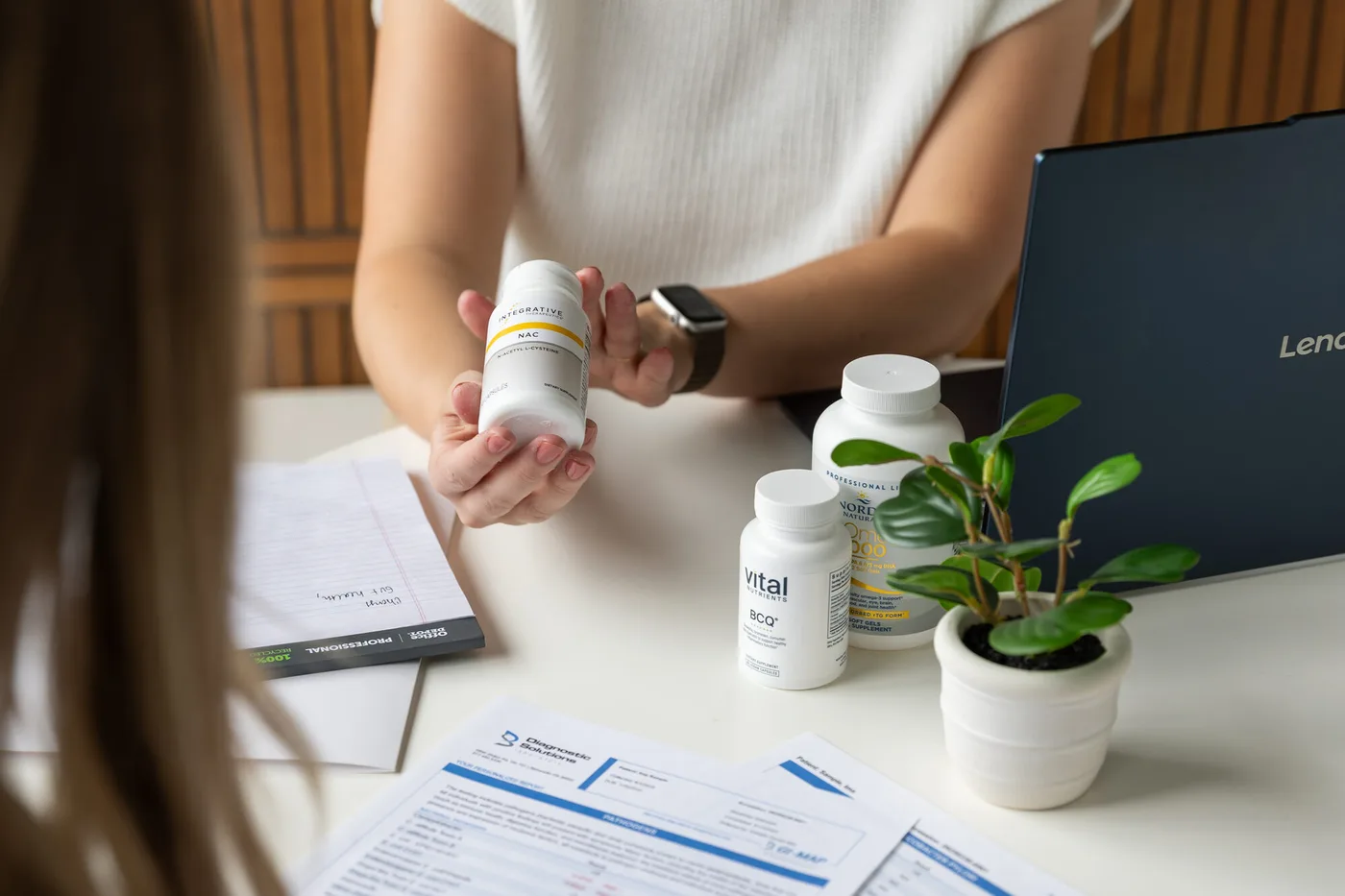 Dr. Abbie going over supplements and paperwork with a patient at Foundations Natural Health